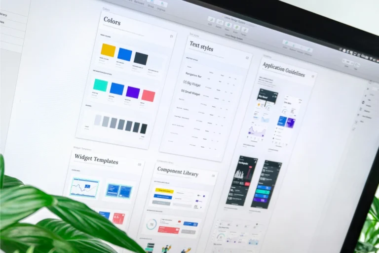 Design system aplikacji z komponentami UI, kolorami i stylami tekstu wyświetlony na ekranie komputera